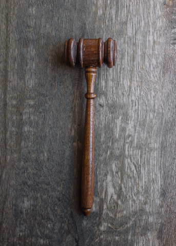 Wooden gavel on a textured wooden surface, symbolizing legal authority and courtroom proceedings related to DUI charges and criminal defense in Virginia.