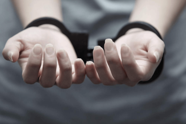 Person's hands in handcuffs, illustrating the consequences of arrest and legal challenges in criminal defense, relevant to plea bargains and DUI laws in Virginia.