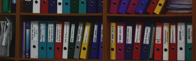 Colorful file folders organized on a shelf, representing legal documentation and case management related to Coastal Virginia Law Group's services.
