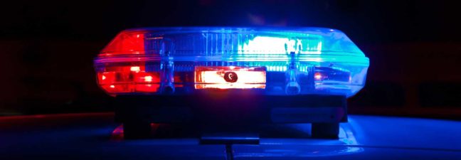 Police lights flashing in red and blue, symbolizing law enforcement presence related to DWI and DUI legal topics.