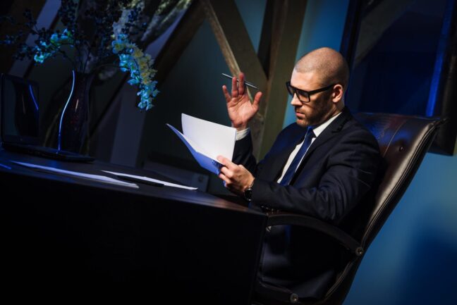 Business professional reviewing documents at desk, emphasizing legal expertise in military divorce services.